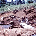 1960 Dec - Digging up building material from army dump Banika